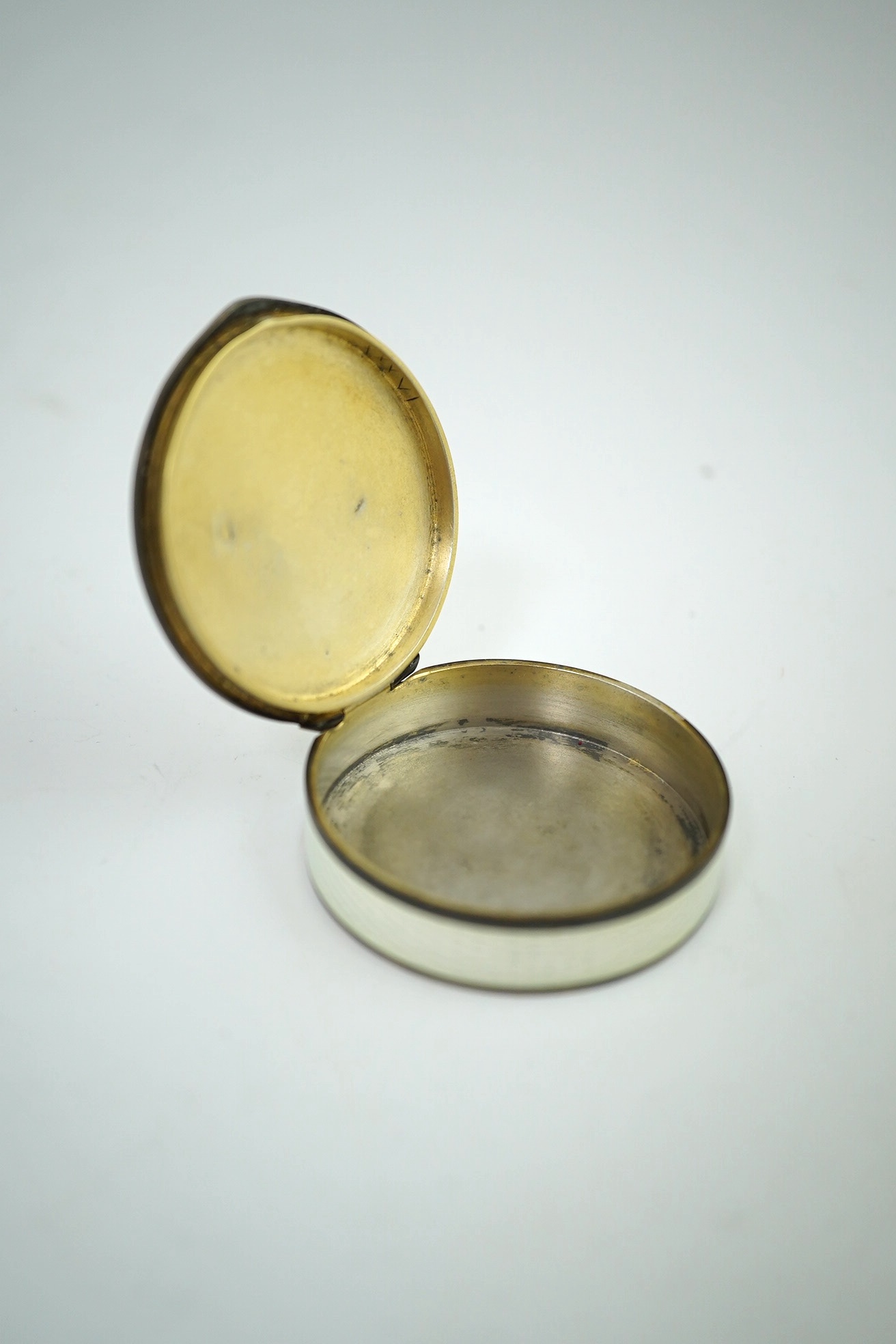 An early 20th century Scandinavian silver and enamel circular pill box, 4.2cm. Condition - poor.